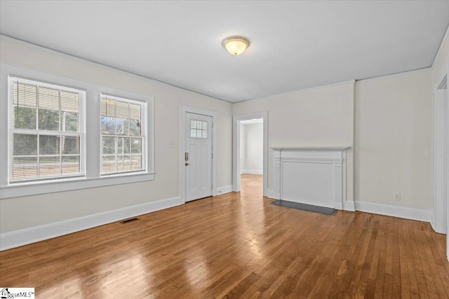 entryway with visible vents, baseboards, and wood finished floors