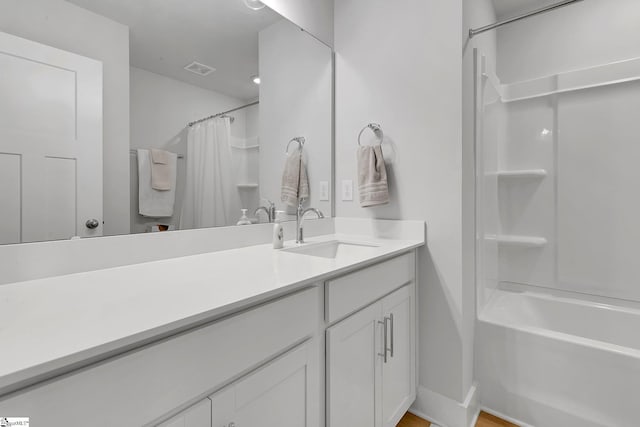 full bath featuring shower / bath combo, visible vents, and vanity