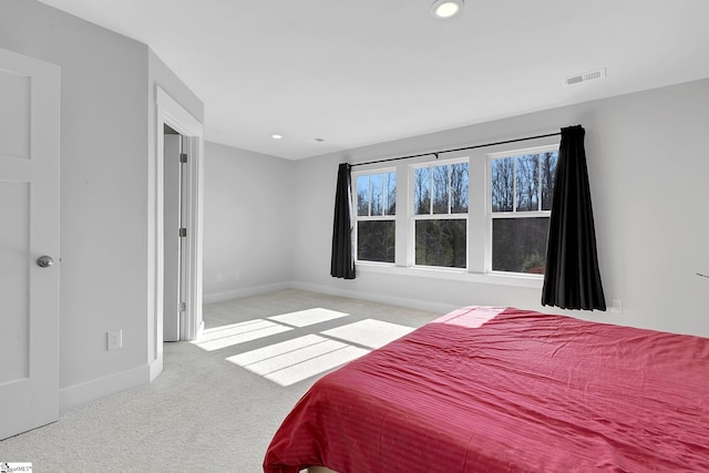 carpeted bedroom with recessed lighting, visible vents, and baseboards