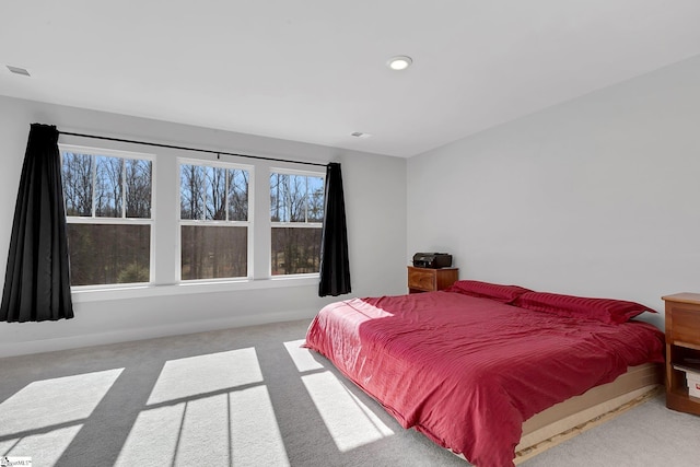 carpeted bedroom featuring recessed lighting, visible vents, and baseboards