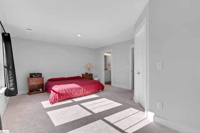 carpeted bedroom with recessed lighting, ensuite bath, visible vents, and baseboards