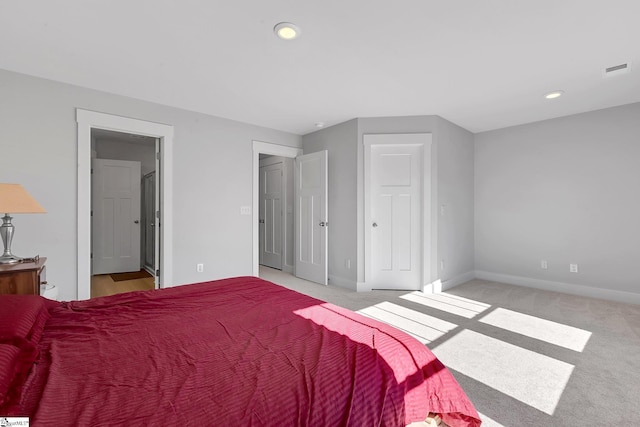 bedroom featuring recessed lighting, baseboards, visible vents, and light colored carpet