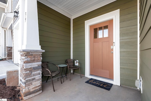 view of exterior entry featuring a porch