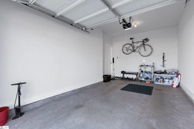 garage with a garage door opener and baseboards