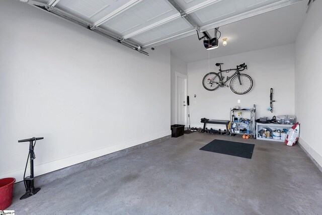 garage featuring baseboards and a garage door opener