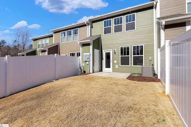 back of property with fence and central air condition unit