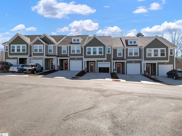 townhome / multi-family property featuring a garage and a residential view