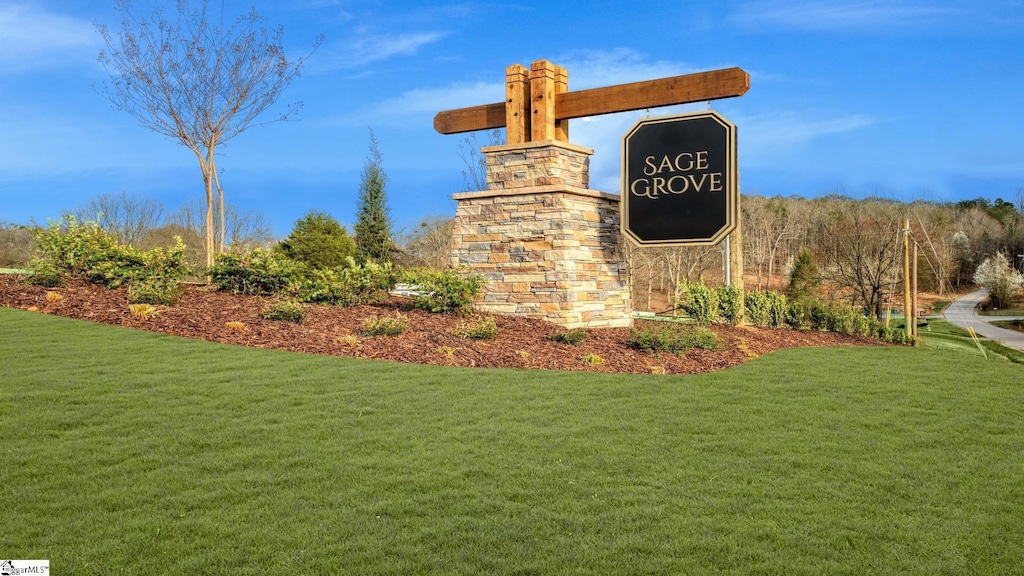 community sign featuring a lawn