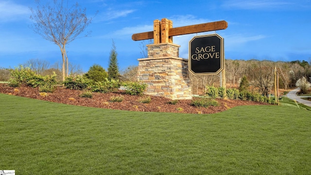 community sign featuring a lawn