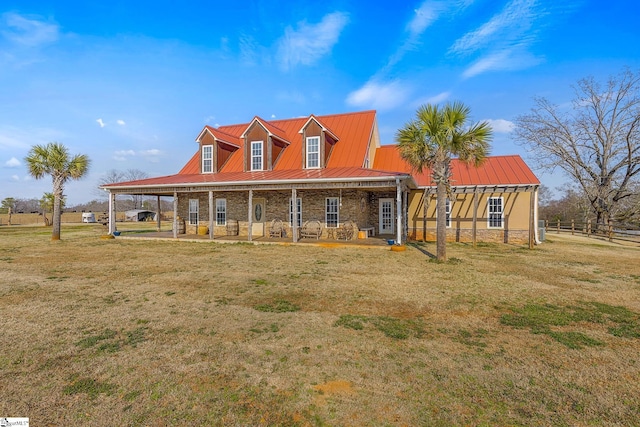 farmhouse inspired home featuring metal roof, stone siding, a standing seam roof, and a front yard