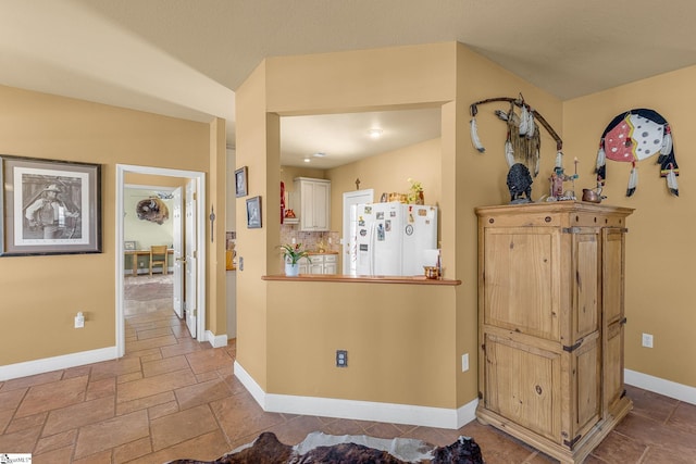 4101 Abbeville Hwy, Anderson, SC 29624 - kitchen featuring white fridge with ice dispenser, stone tile floors, decorative backsplash, and baseboards