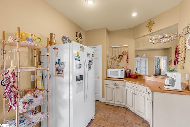 4101 Abbeville Hwy, Anderson, SC 29624 - kitchen with white appliances, stone tile floors, white cabinets, a peninsula, and light countertops