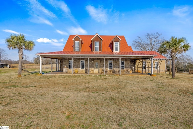 country-style home featuring stone siding, a front lawn, metal roof, and a standing seam roof