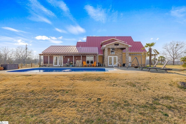 4101 Abbeville Hwy, Anderson, SC 29624 - back of property featuring metal roof, stone siding, french doors, a standing seam roof, and a patio area