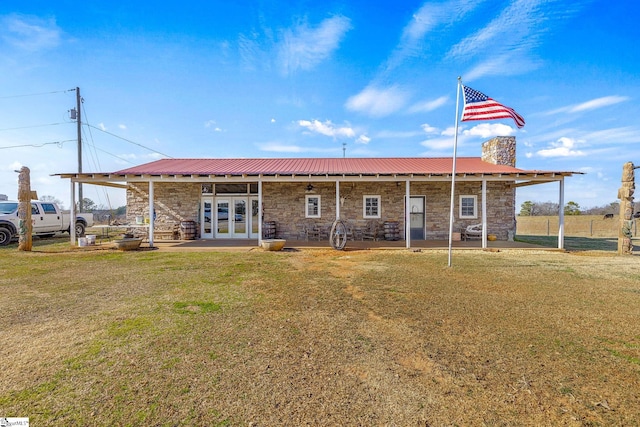 4101 Abbeville Hwy, Anderson, SC 29624 - rear view of property featuring french doors, a patio, a chimney, metal roof, and stone siding