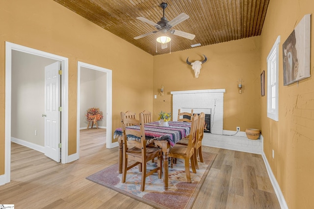 4101 Abbeville Hwy, Anderson, SC 29624 - dining area with light wood-type flooring, wooden ceiling, a brick fireplace, and baseboards