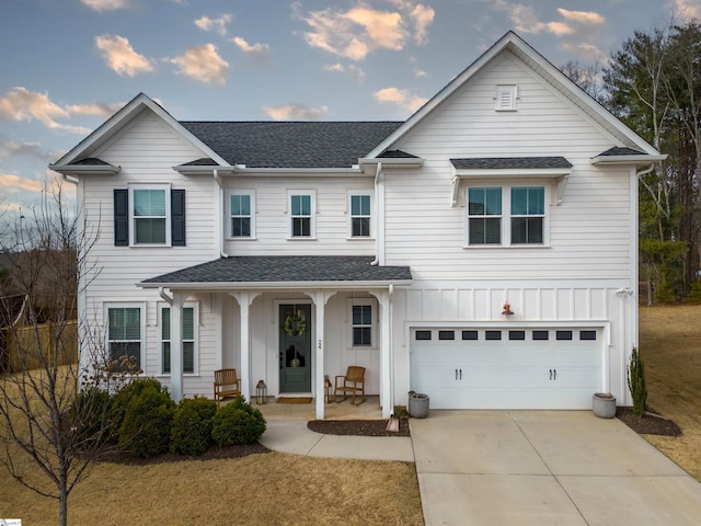 view of front of property featuring a shingled roof, covered porch, concrete driveway, board and batten siding, and a garage