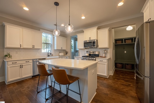 kitchen with appliances with stainless steel finishes, light countertops, and white cabinetry