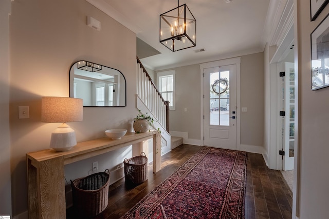 foyer entrance with dark wood-type flooring, visible vents, baseboards, and stairs