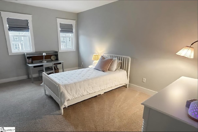 bedroom with carpet, multiple windows, and baseboards