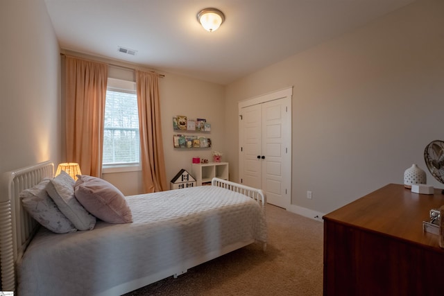 carpeted bedroom with radiator heating unit, a closet, visible vents, and baseboards