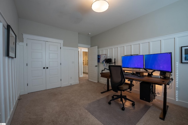 carpeted office featuring a decorative wall