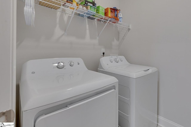 clothes washing area with laundry area and independent washer and dryer