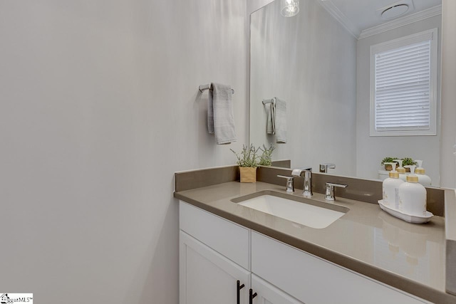 bathroom with ornamental molding and vanity