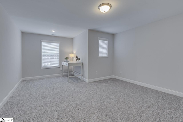 interior space with carpet floors, visible vents, and baseboards