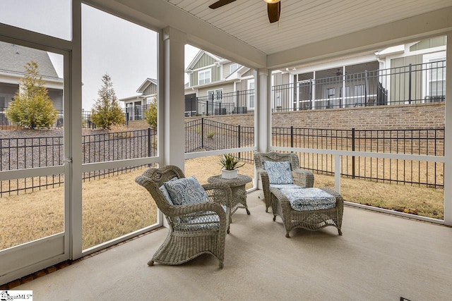 sunroom featuring a ceiling fan