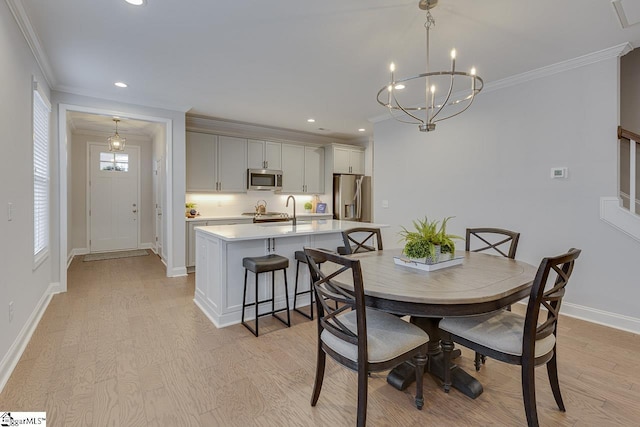 dining room with recessed lighting, a notable chandelier, baseboards, ornamental molding, and light wood finished floors