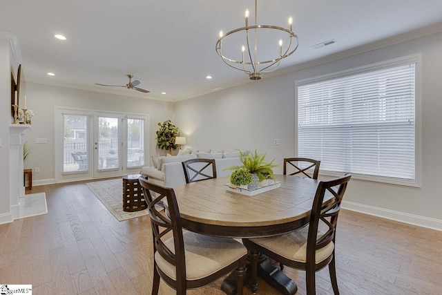 dining area with ornamental molding, visible vents, baseboards, and wood finished floors