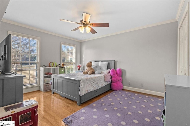 bedroom featuring light wood-type flooring, baseboards, ornamental molding, and a ceiling fan