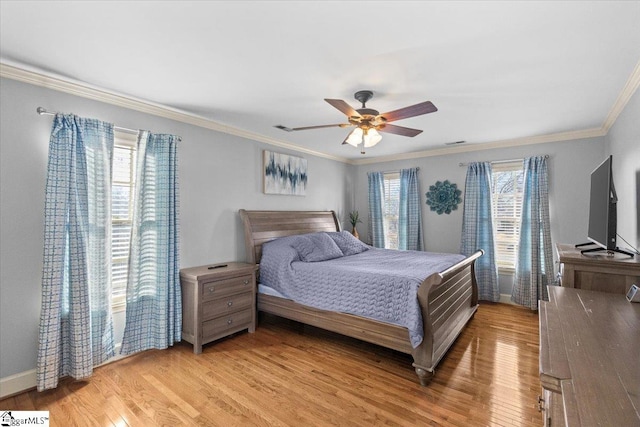 bedroom with light wood finished floors, baseboards, a ceiling fan, and crown molding