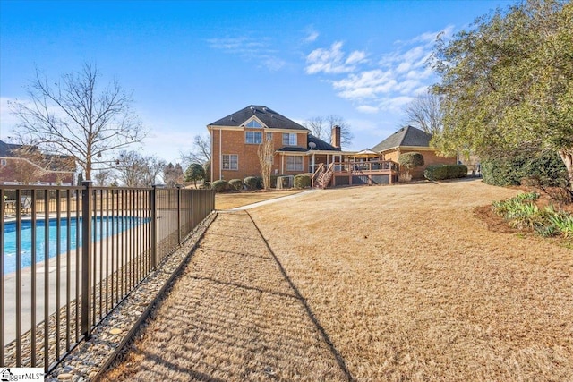 view of yard featuring fence and a community pool