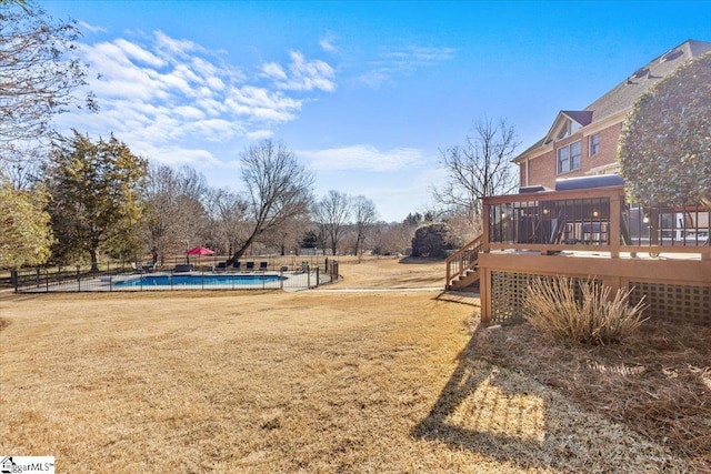 view of yard with a fenced in pool, fence, stairway, and a wooden deck