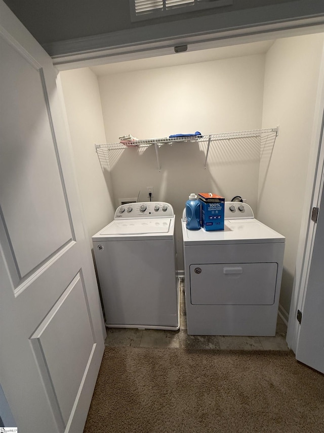 clothes washing area featuring laundry area and washing machine and clothes dryer