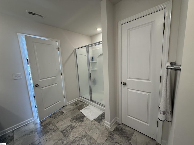 full bathroom featuring a shower stall, visible vents, and baseboards