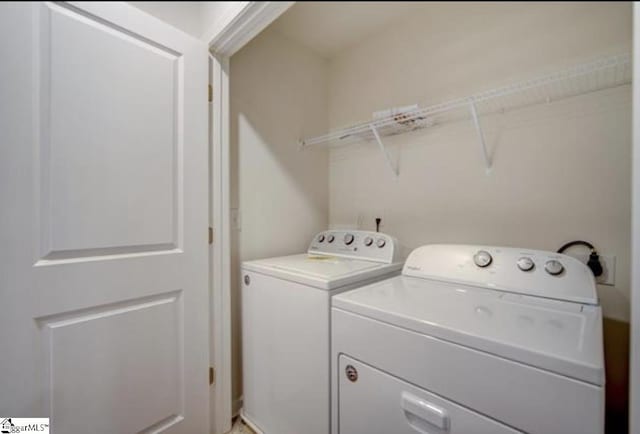 clothes washing area with laundry area and washer and clothes dryer