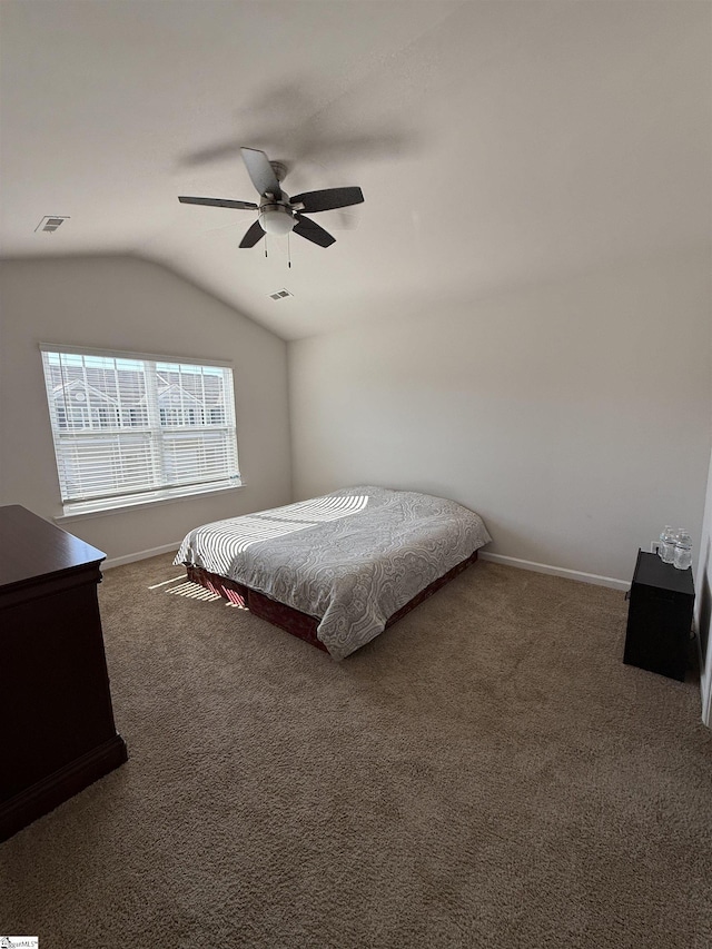 bedroom with carpet, lofted ceiling, visible vents, a ceiling fan, and baseboards