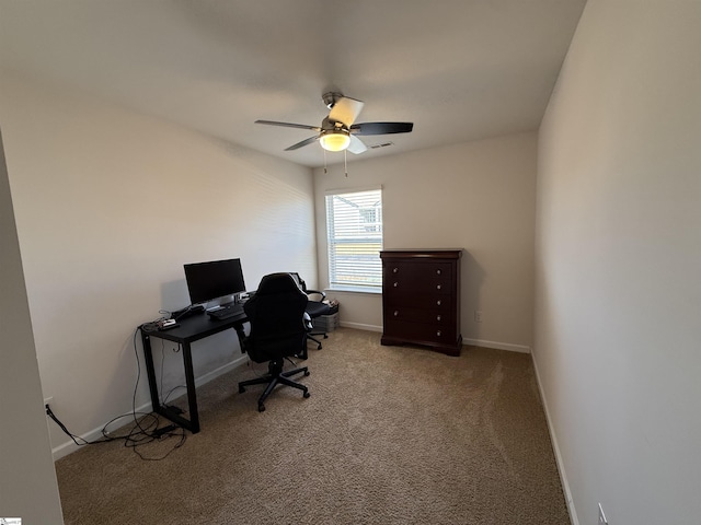 office area with light carpet, visible vents, a ceiling fan, and baseboards