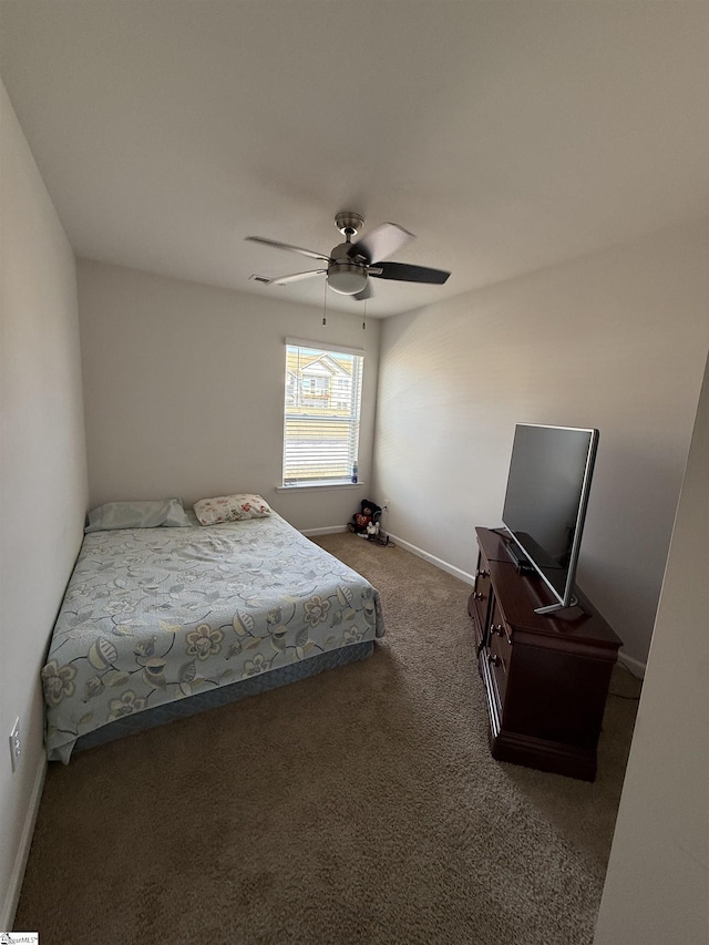 bedroom with a ceiling fan, carpet, and baseboards