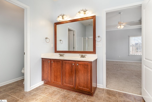 full bath with double vanity, a ceiling fan, toilet, and a sink