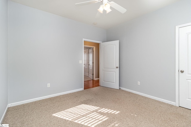 unfurnished bedroom with carpet, baseboards, and a ceiling fan