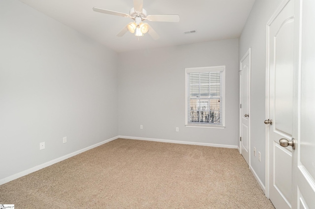 unfurnished bedroom with light carpet, ceiling fan, visible vents, and baseboards