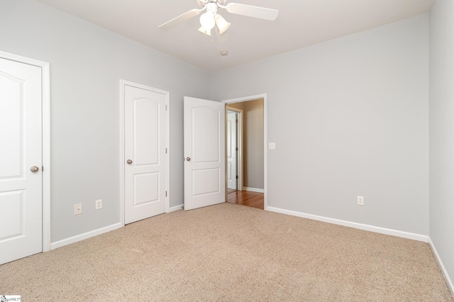 unfurnished bedroom with ceiling fan, baseboards, and carpet flooring