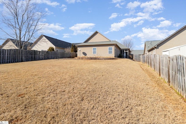 exterior space with a fenced backyard and a yard