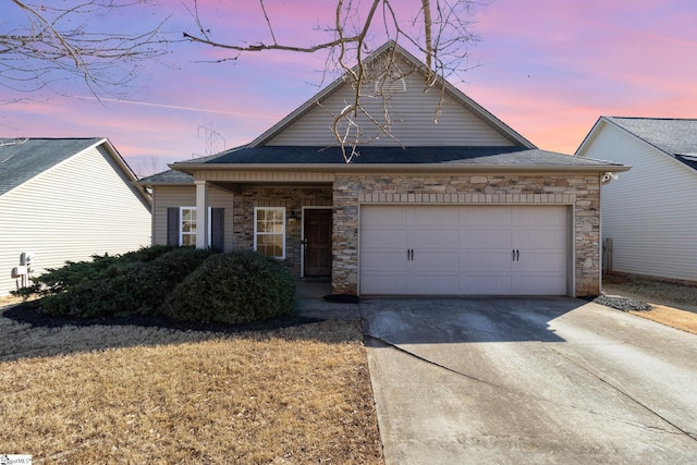 view of front facade with stone siding, driveway, and an attached garage