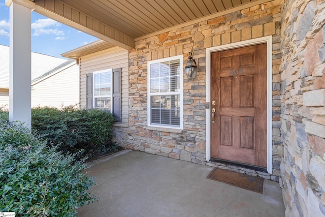 view of exterior entry featuring stone siding