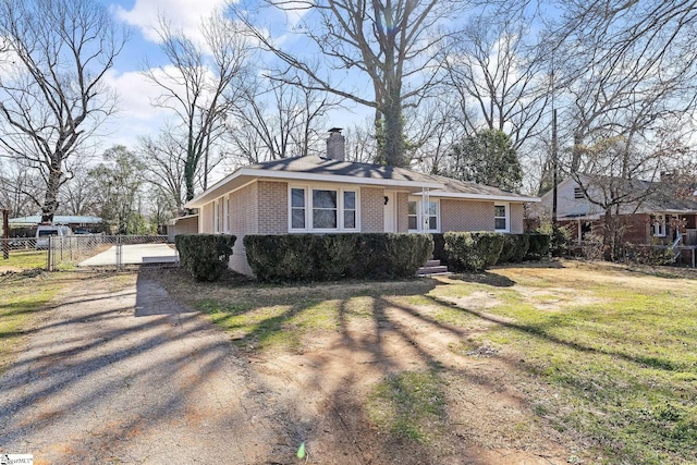 view of front of house with a gate, brick siding, fence, and a chimney